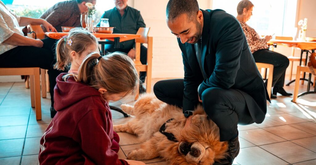A heartwarming family scene with children and a dog in a cozy indoor setting.