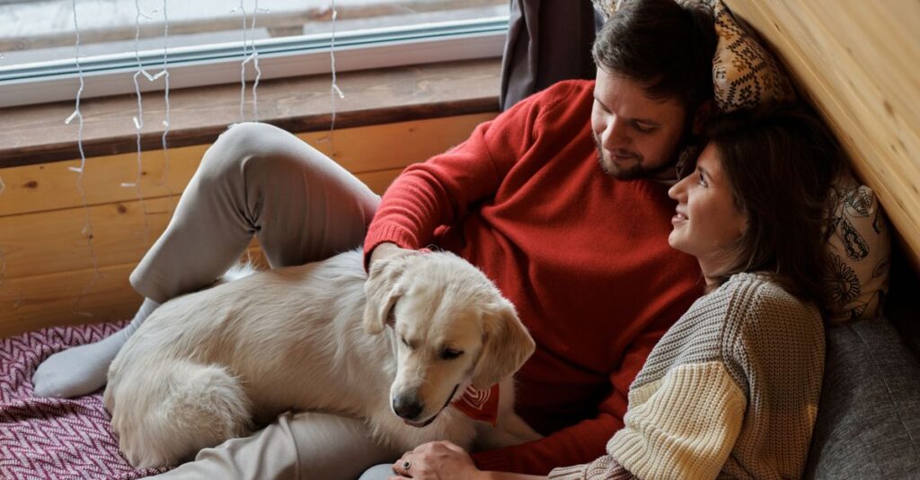Couple and dog enjoying a cozy moment in an attic room, winter vibes.