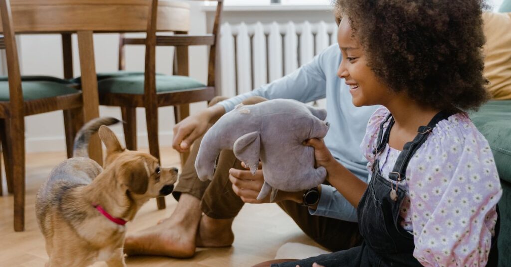 A joyful family interaction with a dog and child playing indoors, capturing a moment of bonding.